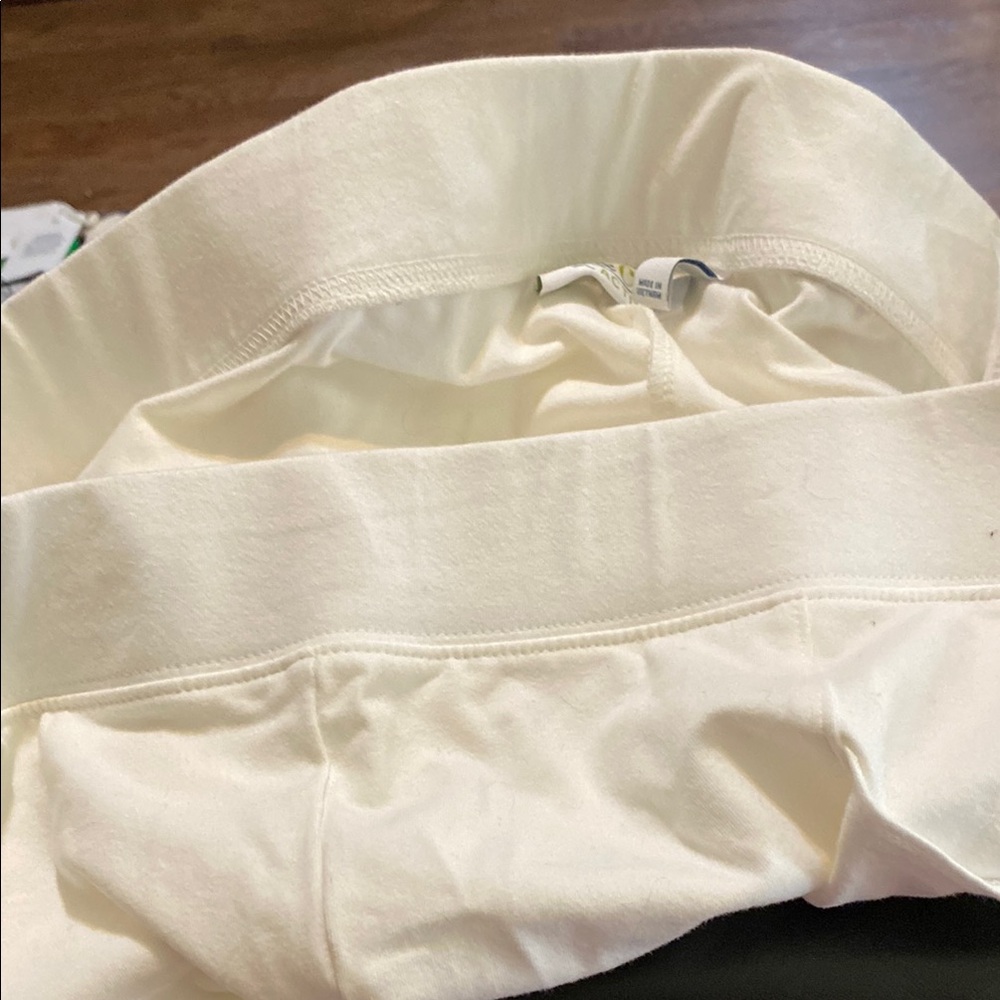 Cream High-Waisted pants like below knee skimmer.